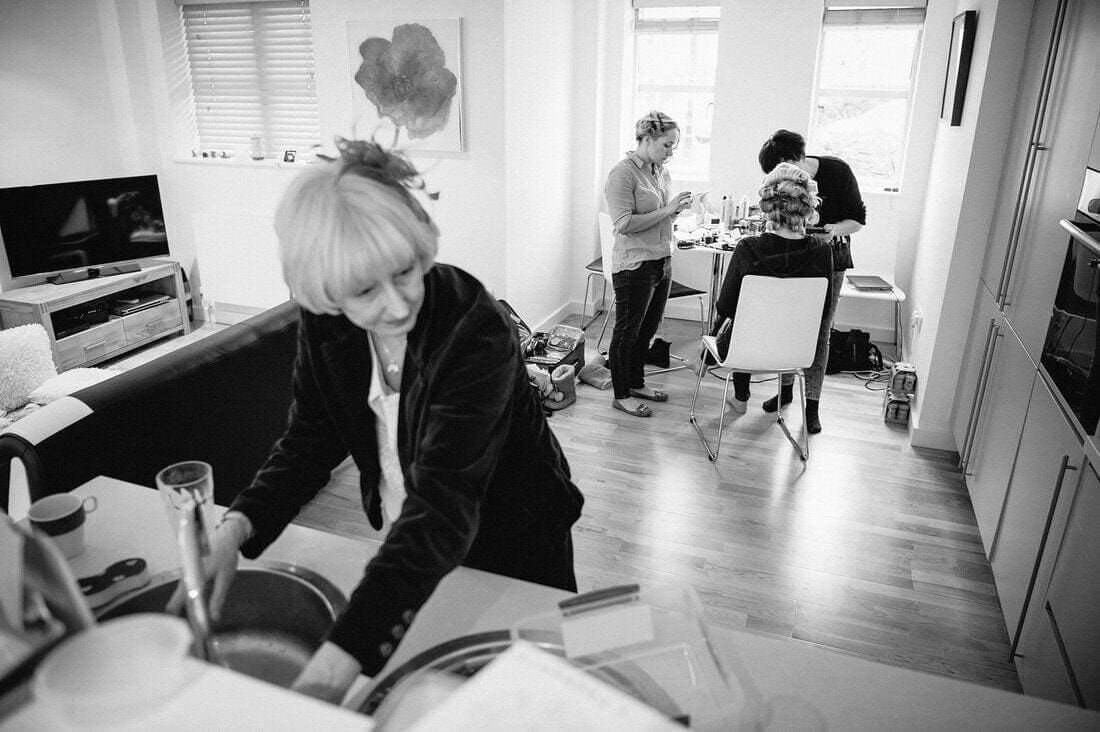 mum washes dishes while daughter gets ready for her wedding.
