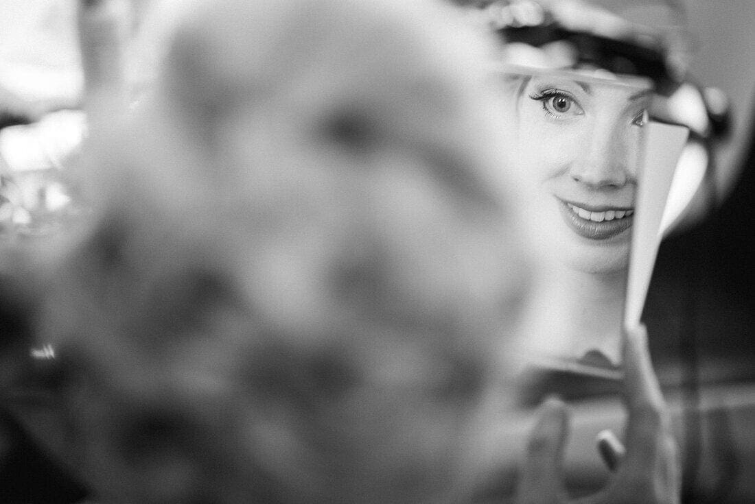 bride checks makeup in mirror