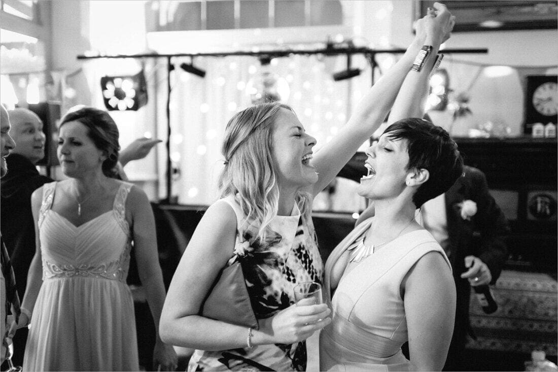 wedding guests sing along on the dance floor