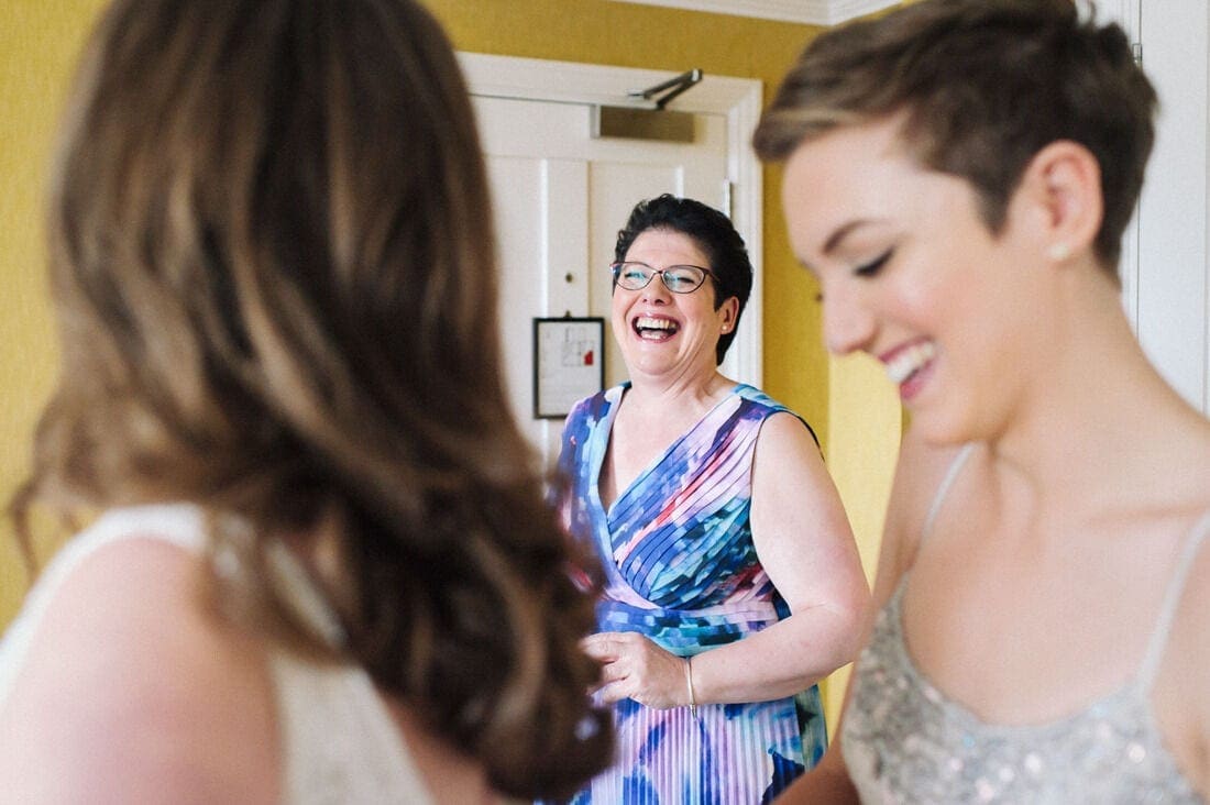 the mother of the bride has a laugh during bridal prep