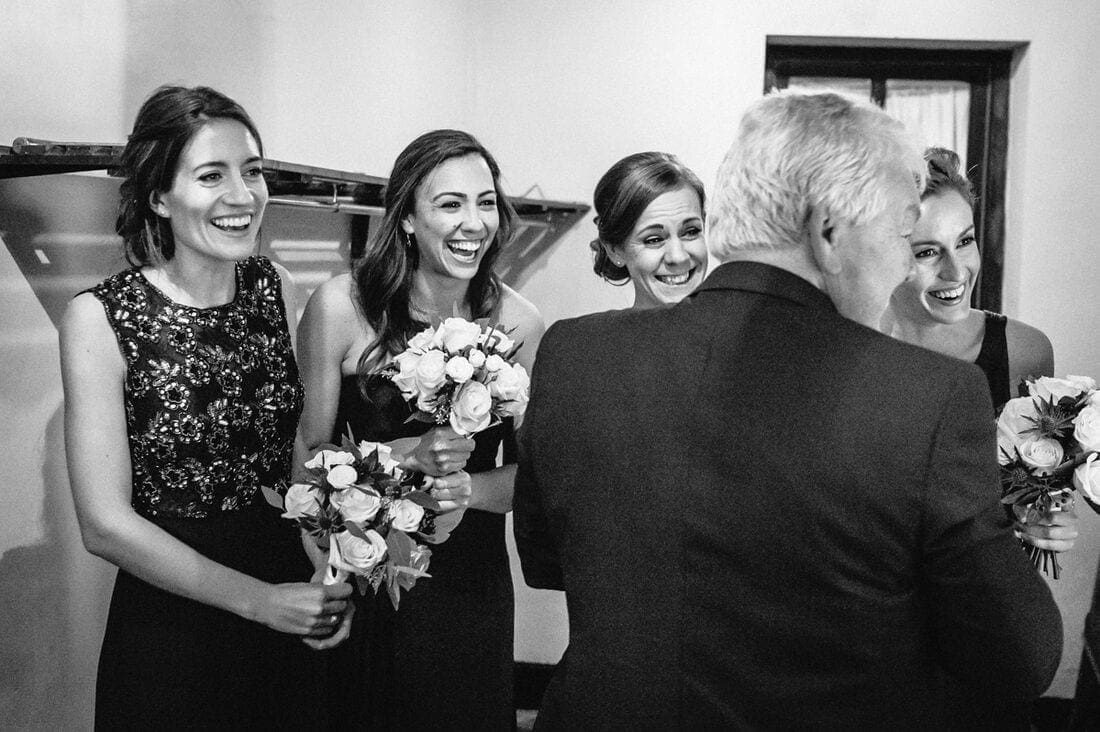 bridesmaids react to the arrival of the bride