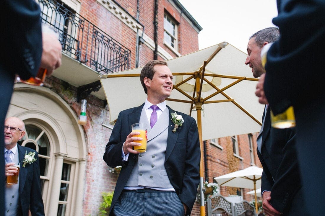 the groom enjoying a drink before his wedding