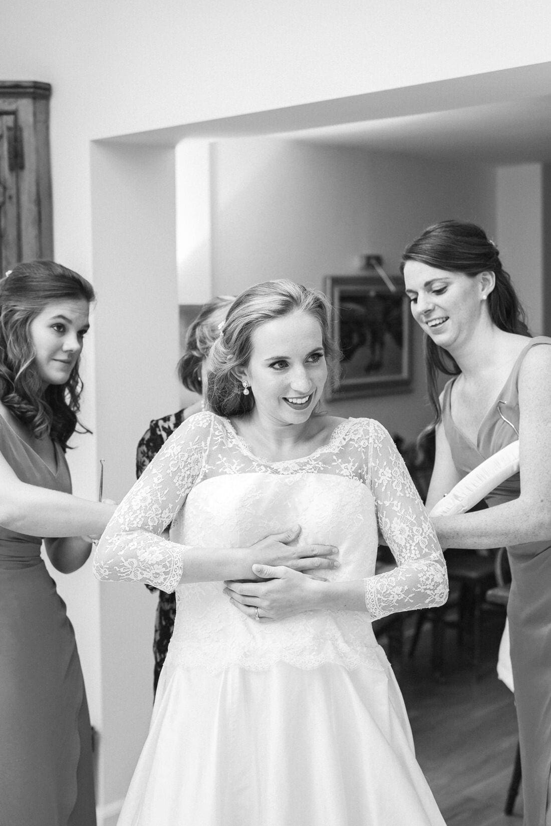 bride putting on her wedding dress