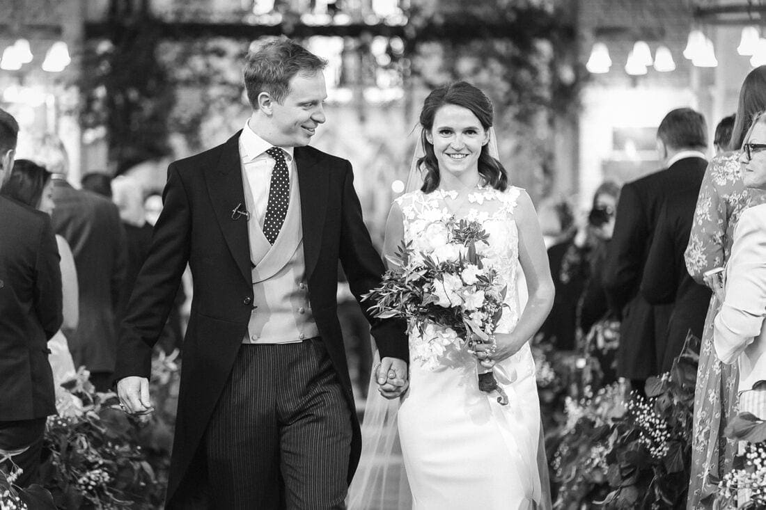 the married couple leave church after their wedding ceremony