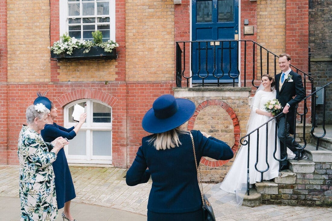 wedding guests taking their own photos of the couple