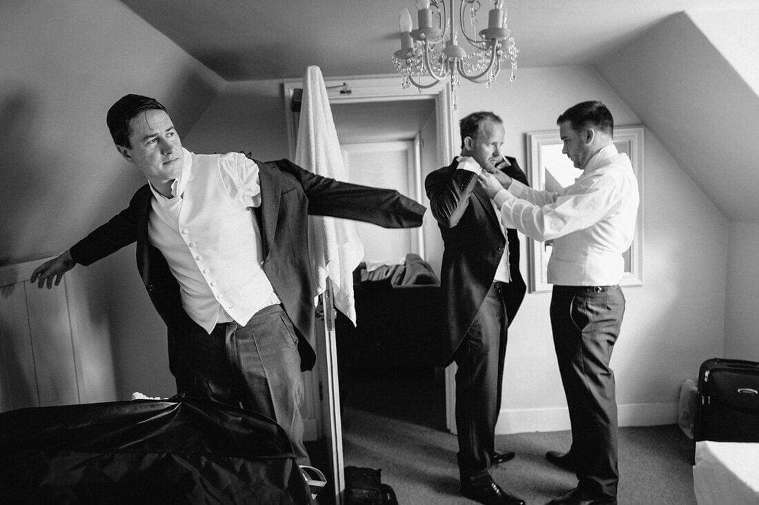 groomsmen getting dressed for the wedding ceremony