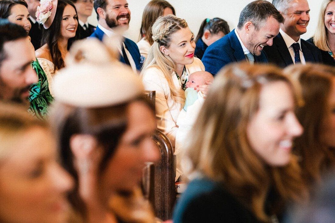 a smiley wedding guest and baby