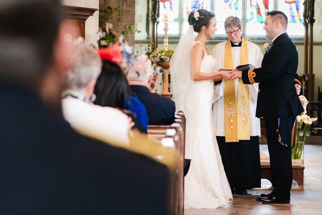 bride and groom exchange wedding rings
