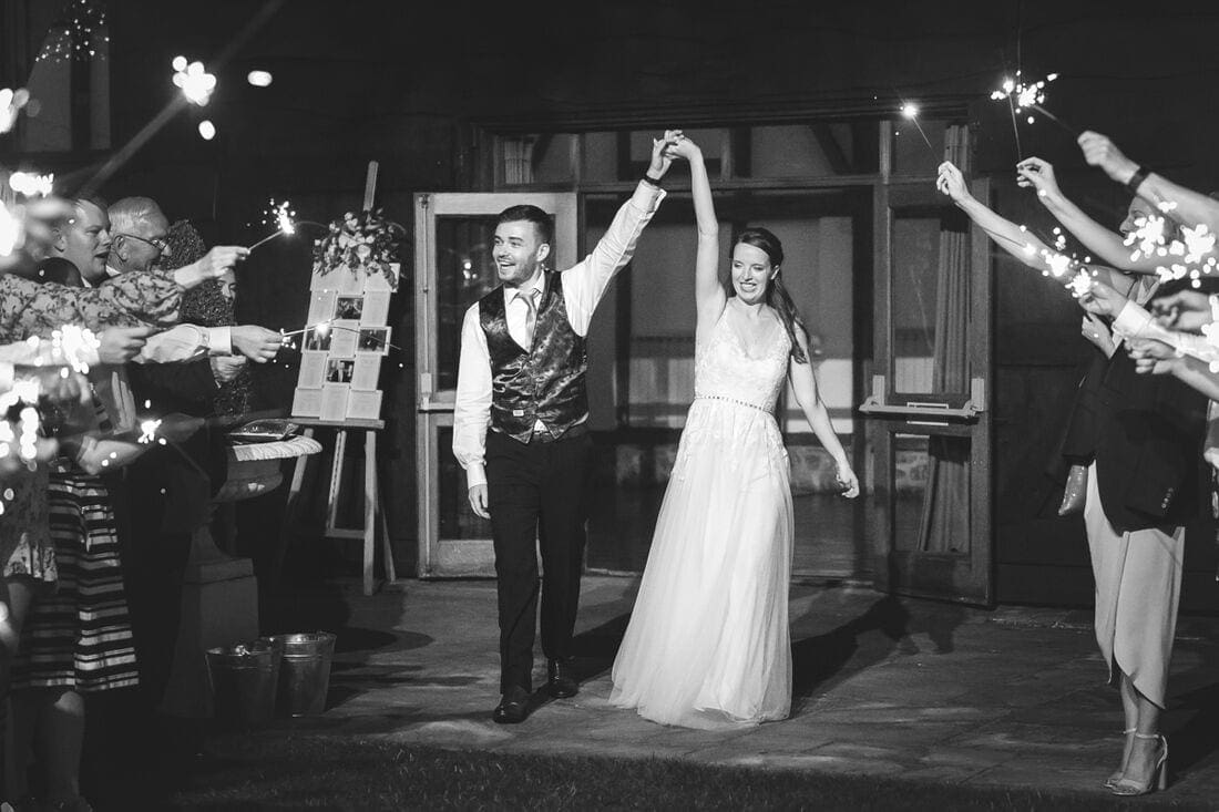 sparklers as the couple leave their Loseley Park wedding reception