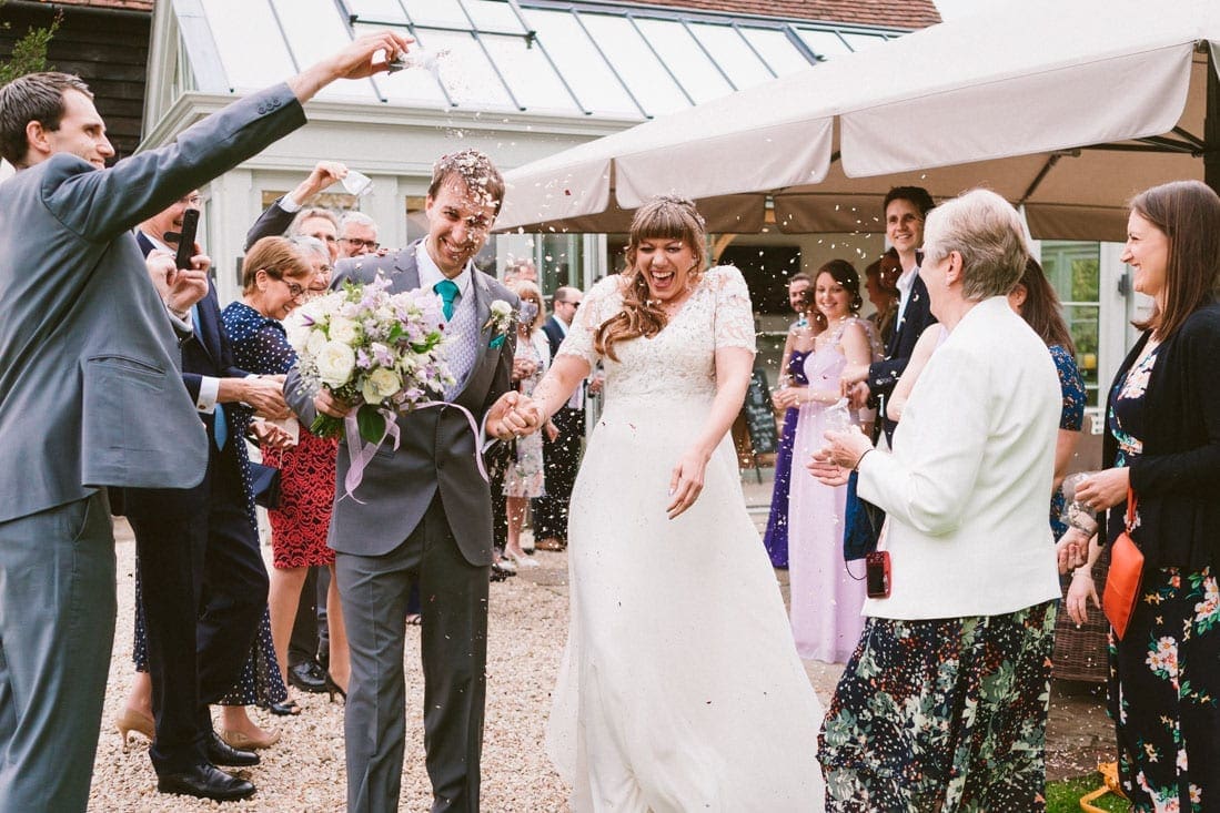 the newleyweds enjoying confetti after getting married at Gate Street Barn