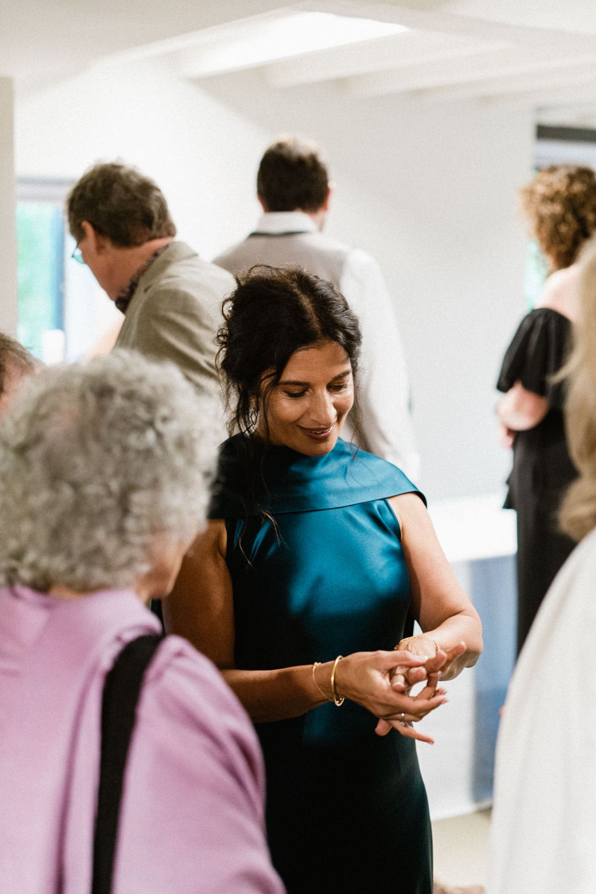 bride shows off her wedding ring to friends