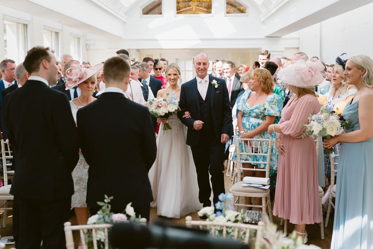 the entrance of the bride and father to the wedding ceremony