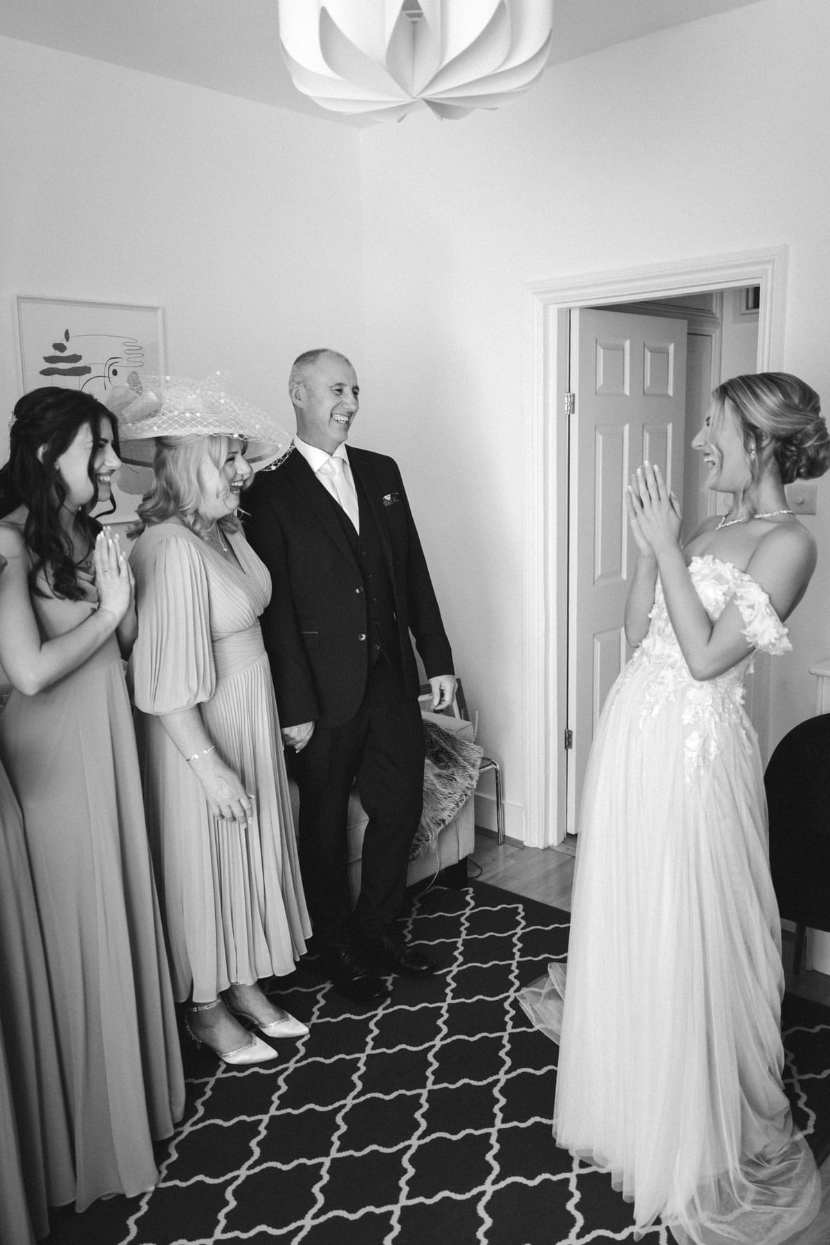 parents of the bride get their first look of the bride in her wedding dress