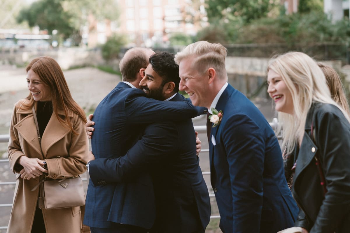 the groom greets wedding guests at the reception in Greenwich