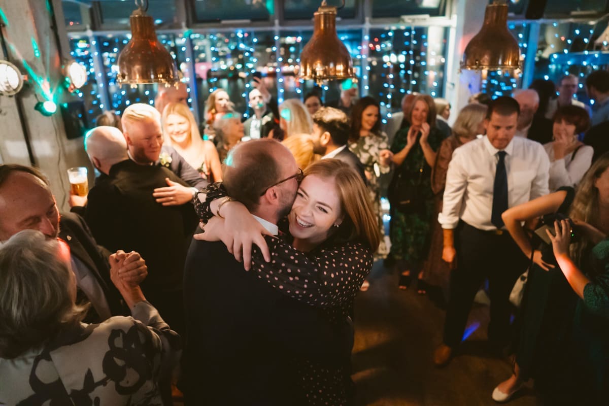 a big hug after the first dance at their wedding