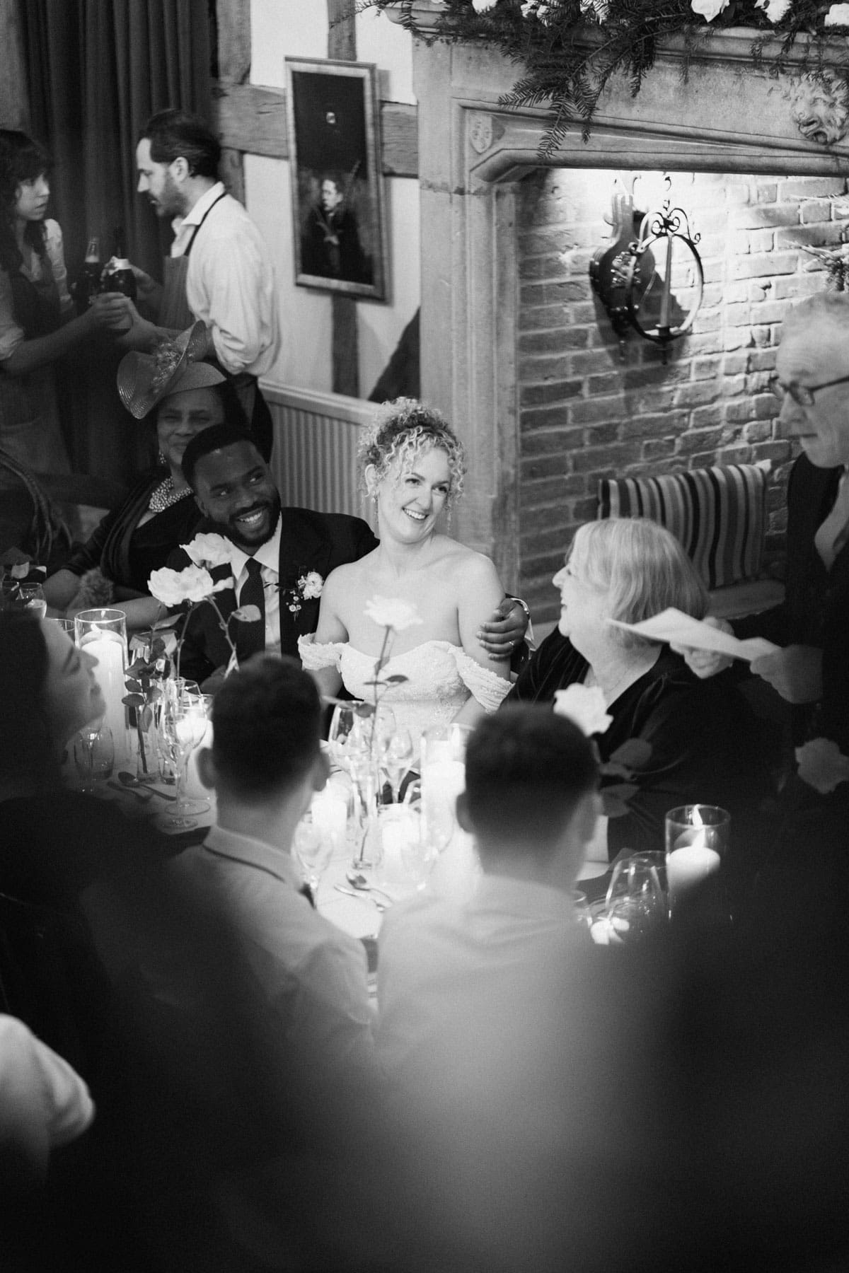 black and white photo of bride reacting to the father of the bride speech
