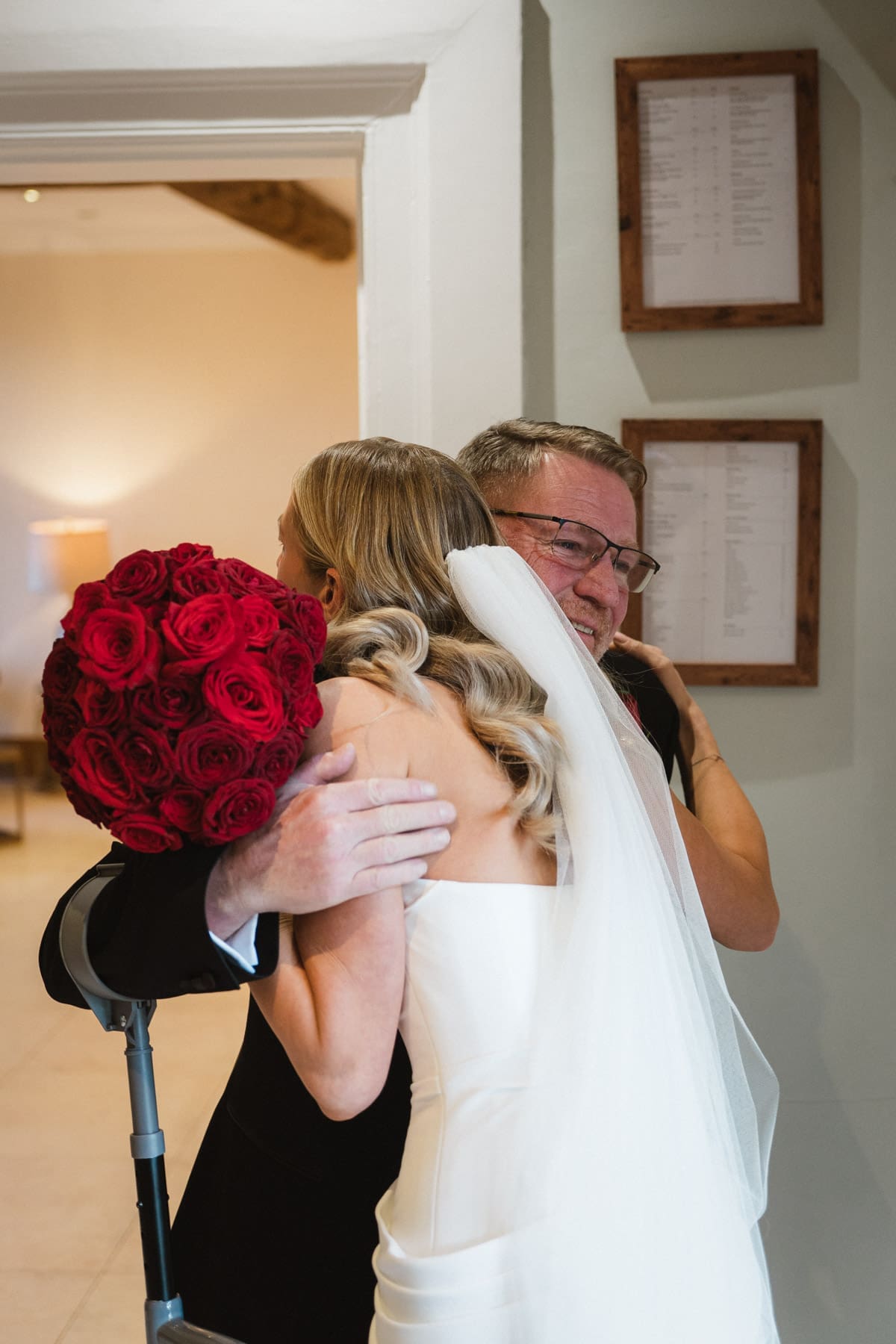 a hug between the bride and the father of the bride before the wedding ceremony begins